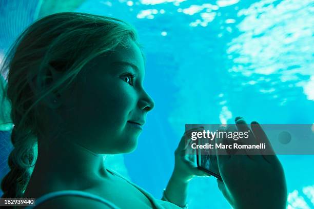 caucasian girl taking pictures in aquarium - atlanta aquarium stock pictures, royalty-free photos & images