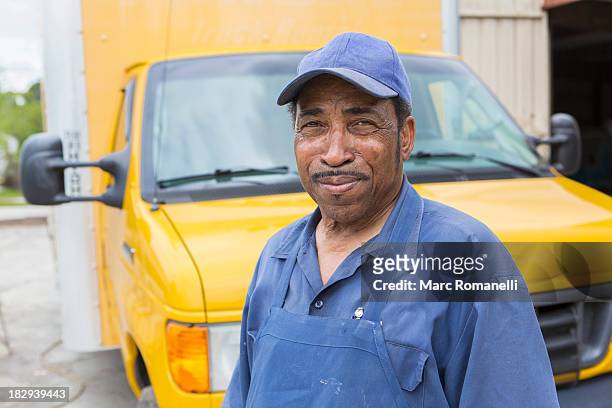 african american worker smiling by truck - tradesman van stock pictures, royalty-free photos & images