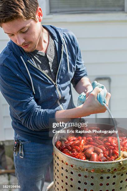 caucasian man cooking crawfish outdoors - crayfish stock pictures, royalty-free photos & images