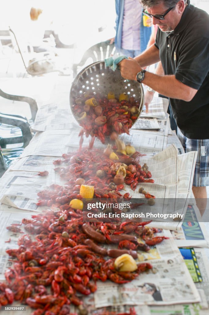 Caucasian man serving crawfish at boil