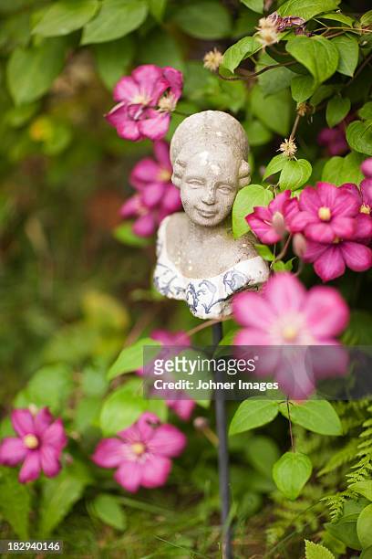 bust of woman and flower in garden - sculpture bust stock pictures, royalty-free photos & images