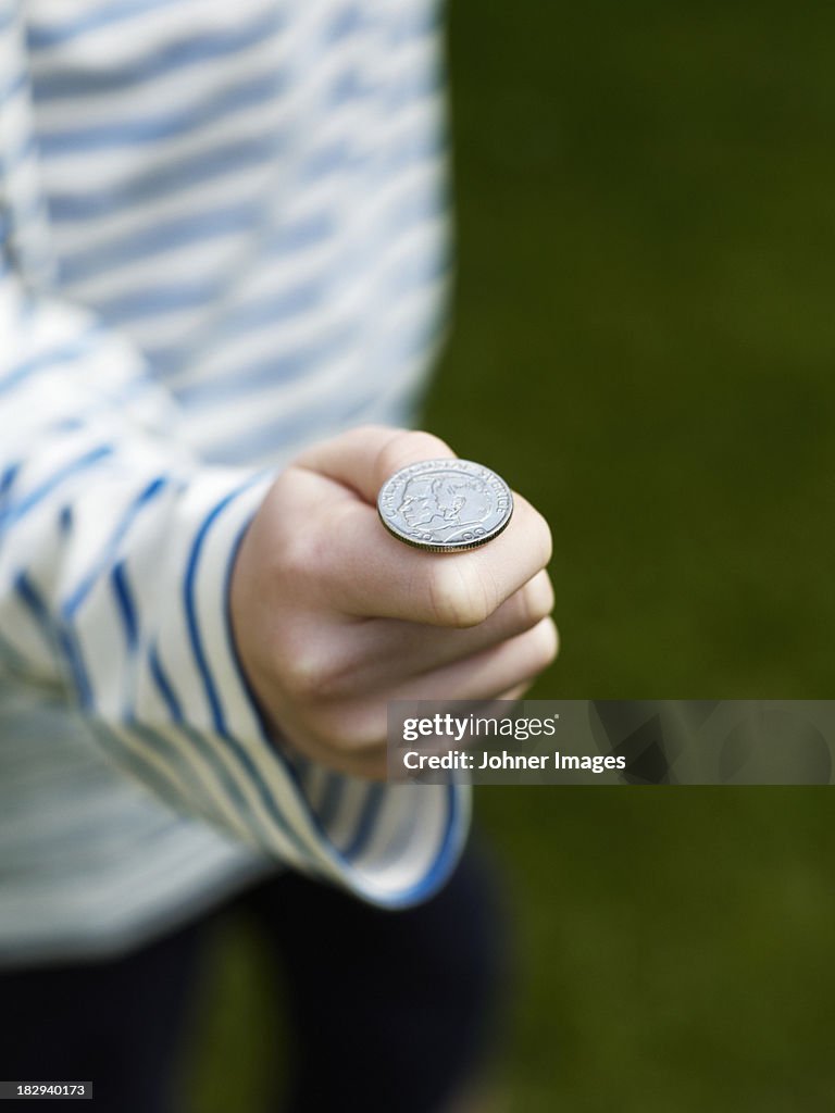 Hand holding coin