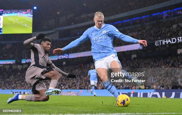 Manchester City striker Erling Haaland is challenged by Emerson Royal of Tottenham during the Premier League match between Manchester City and...