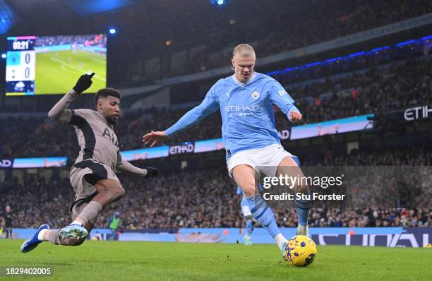 Manchester City striker Erling Haaland is challenged by Emerson Royal of Tottenham during the Premier League match between Manchester City and...