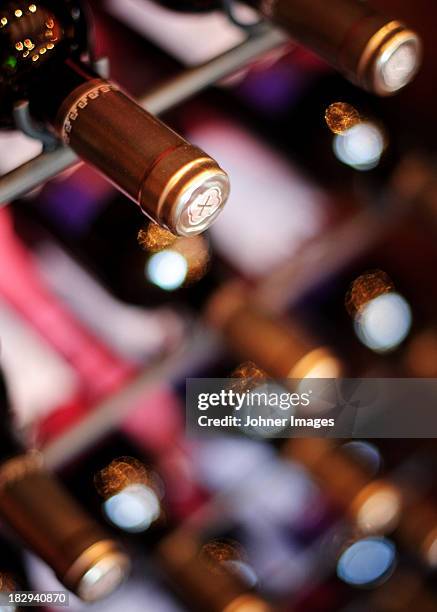 close-up of wine bottles in cellar - chai photos et images de collection