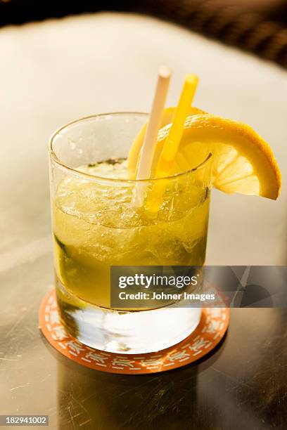 caipirinha drink garnished with lemon slices - caipirinha stock pictures, royalty-free photos & images