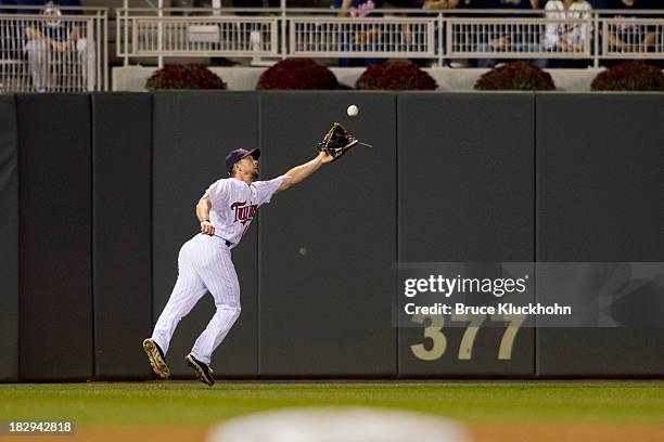 Clete Thomas of the Minnesota Twins fields a ball hit by the Detroit Tigers on September 24, 2013 at Target Field in Minneapolis, Minnesota. The...