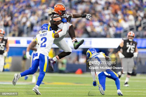 David Njoku of the Cleveland Browns hurdles of Derion Kendrick of the Los Angeles Rams as he runs with the ball during an NFL football game between...