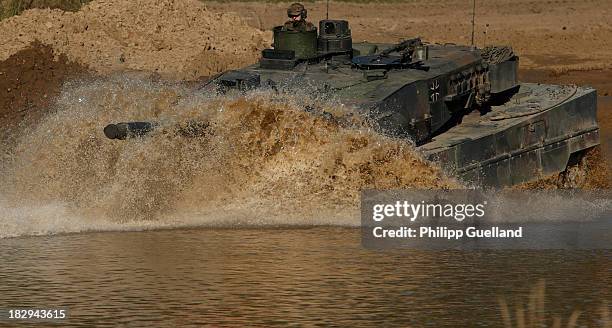 Leopard 2 A6 combat tank crosses a pond during the annual military exercises held for the media at the Bergen military training grounds on October 2,...