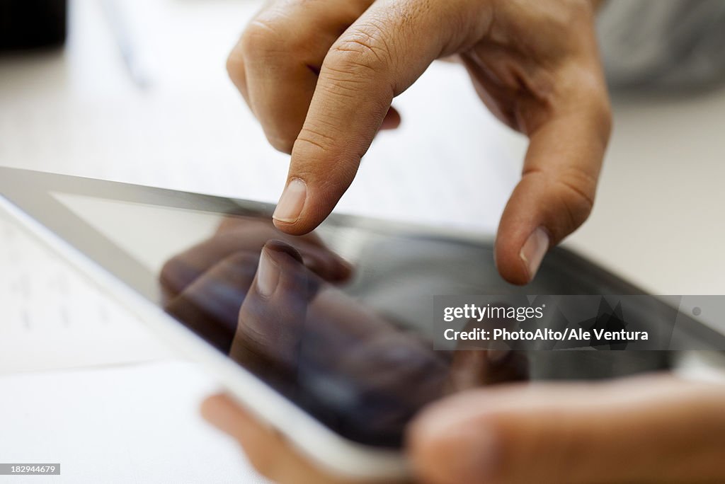 Man using touch screen on Digital tablet, cropped