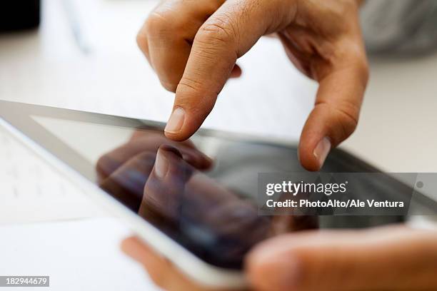 man using touch screen on digital tablet, cropped - ipad close up stock pictures, royalty-free photos & images