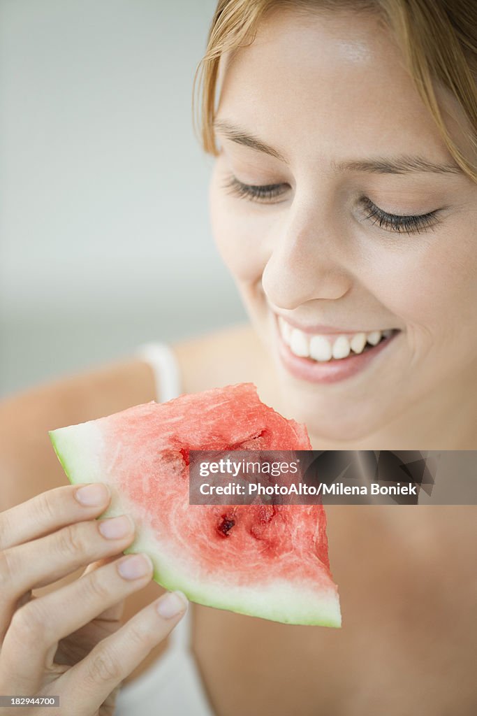 Young woman eating watermelon