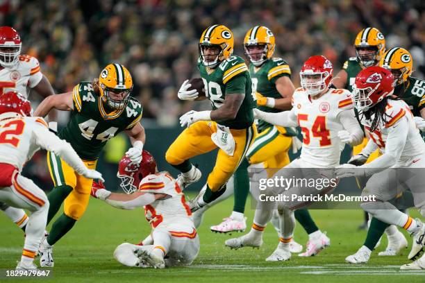 Dillon of the Green Bay Packers carries the ball during the first half as Drue Tranquill of the Kansas City Chiefs attempts to tackle him at Lambeau...