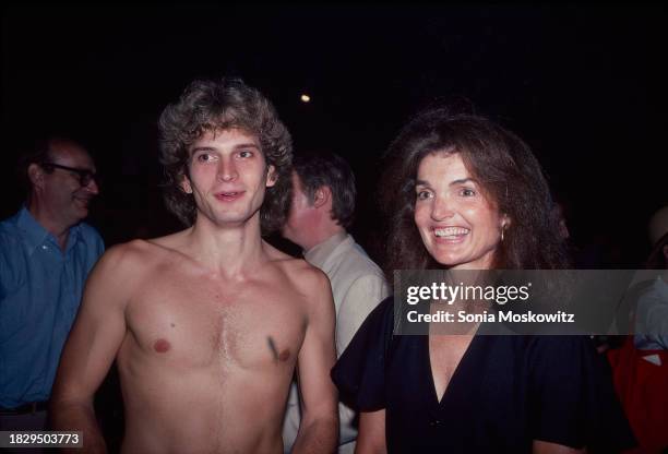 American singer and actor Rex Smith and editor & former First Lady Jacqueline Kennedy Onassis pose together after the Delacorte Theater's opening...
