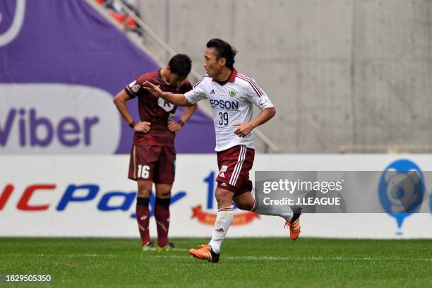 Yoshiro Abe of Matsumoto Yamaga celebrates after scoring the team's first goal during the J.League J1 second stage match between Vissel Kobe and...