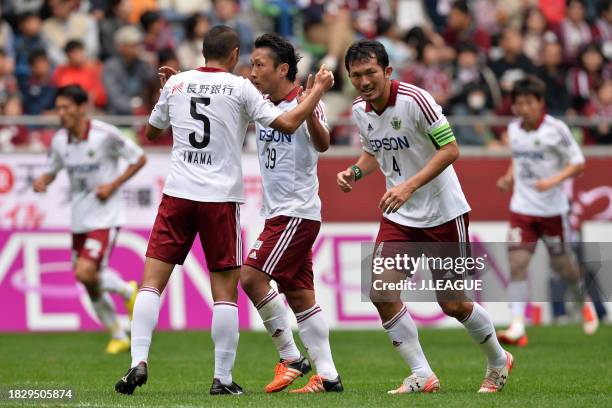 Yoshiro Abe of Matsumoto Yamaga celebrates with teammates Yudai Iwama and Masaki Iida after scoring the team's first goal during the J.League J1...