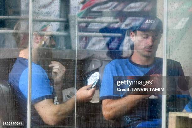 New Zealand's Kane Williamson plays cards along with his teammate after rain washed out the second day of play during the second Test cricket match...