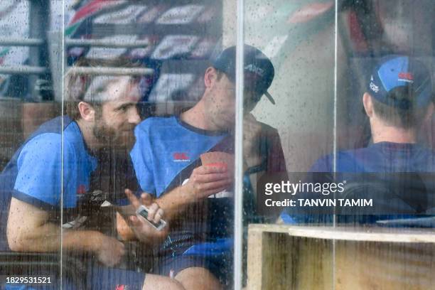 New Zealand's Kane Williamson plays cards along with his teammates after rain washed out the second day of play during the second Test cricket match...