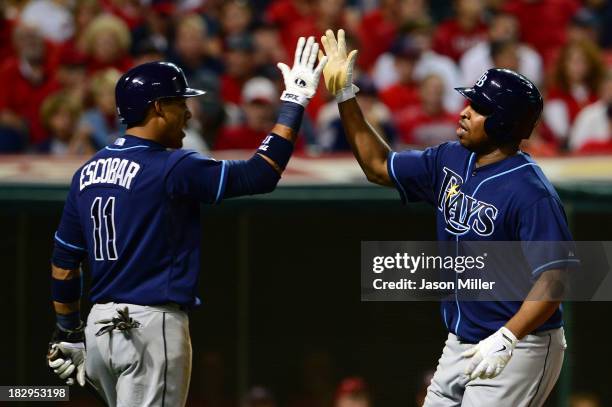 Delmon Young of the Tampa Bay Rays celebrates with his teammate Yunel Escobar of the Tampa Bay Rays after hitting a solo home run in the third inning...