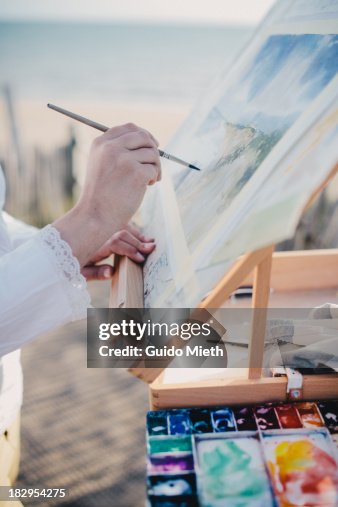 Woman painting on beach Woman painting on beach