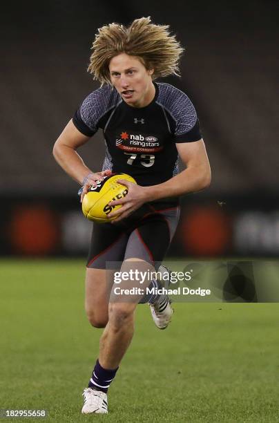 Eli Templeton of the Burnie Dockers, who looks like Dyson Heppell of the Bombers, runs with the ball during the 2013 AFL Draft Combine at Etihad...