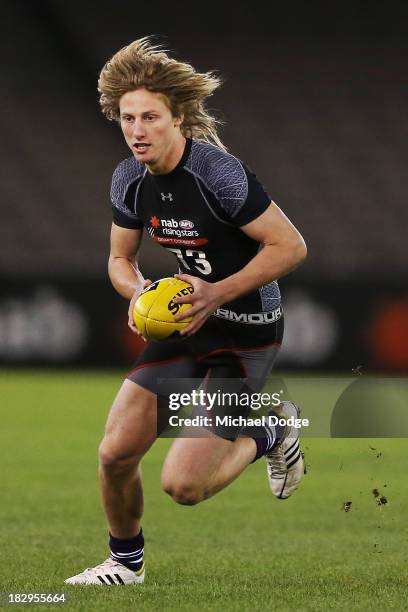 Eli Templeton of the Burnie Dockers, who looks like Dyson Heppell of the Bombers, runs with the ball during the 2013 AFL Draft Combine at Etihad...