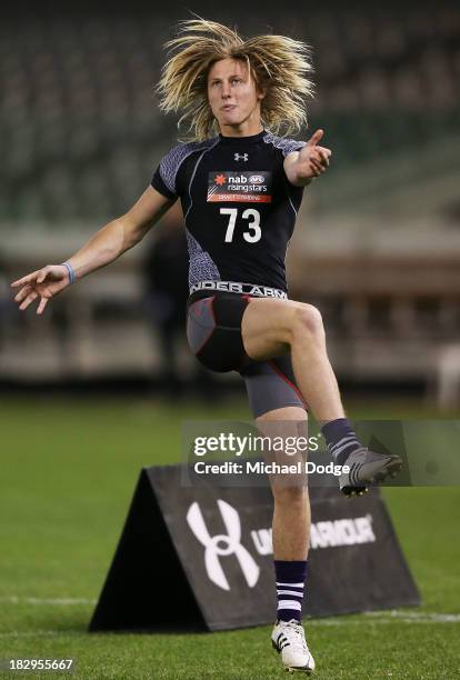 Eli Templeton of the Burnie Dockers, who looks like Dyson Heppell of the Bombers, kicks the ball during the 2013 AFL Draft Combine at Etihad Stadium...