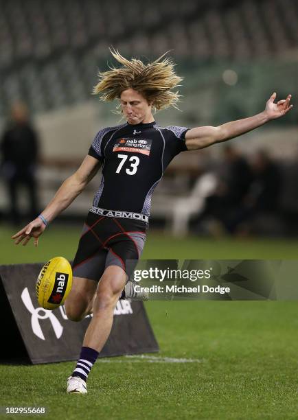 Eli Templeton of the Burnie Dockers, who looks like Dyson Heppell of the Bombers, kicks the ball during the 2013 AFL Draft Combine at Etihad Stadium...