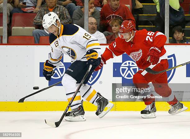 Cody Hodgson of the Buffalo Sabres fights off Cory Emmerton of the Detroit Red Wings in the second period at Joe Louis Arena on October 2, 2013 in...