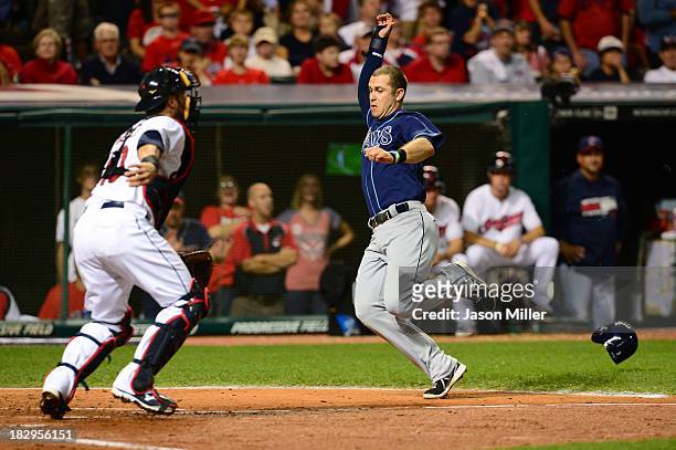 Evan Longoria of the Tampa Bay Rays slides home to score after Desmond Jennings of the Tampa Bay Rays hit an RBI double to left field against Danny...