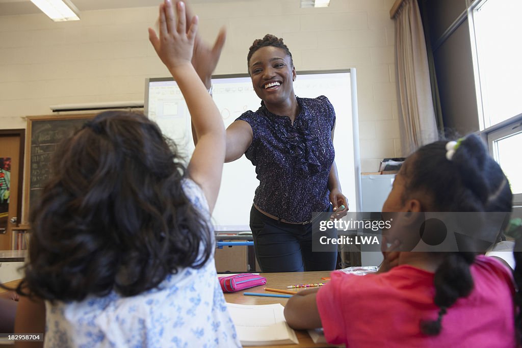 Teacher 'high fiving' student