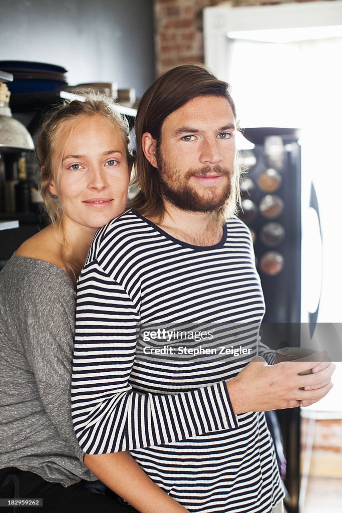 Young couple backlit in kitchen