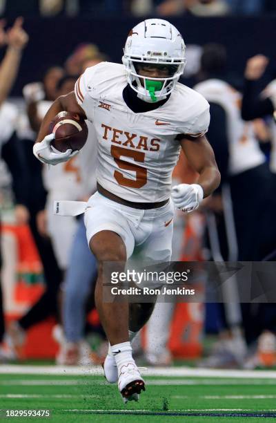 Wide receiver Adonai Mitchell of the Texas Longhorns carries the ball against the Oklahoma State Cowboys in the first half of the Big 12 Championship...