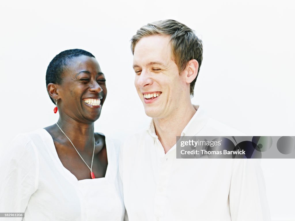Couple standing smiling and laughing