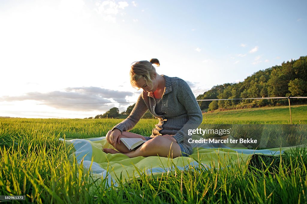 Girl reading in a field