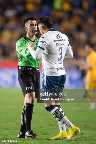 Sebastián Olmedo of Puebla argues with referee Adonai Escobedo during the quarterfinals second leg match between Tigres UANL and Puebla as part of...
