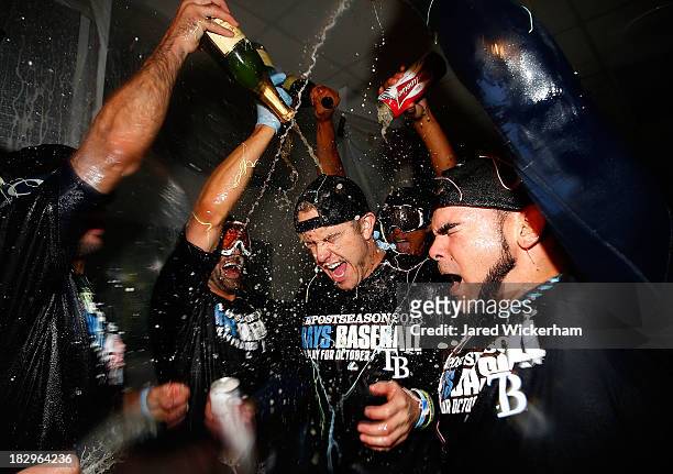 Evan Longoria of the Tampa Bay Rays celebrates in the clubhouse with his teammates following their 4-0 win against the Cleveland Indians during the...