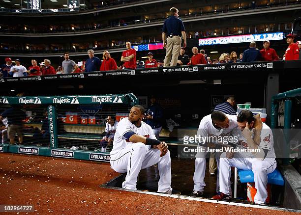 Carlos Santana, Michael Brantley, and Jason Kipnis of the Cleveland Indians sit in the dugout following their 4-0 loss against the Tampa Bay Rays...