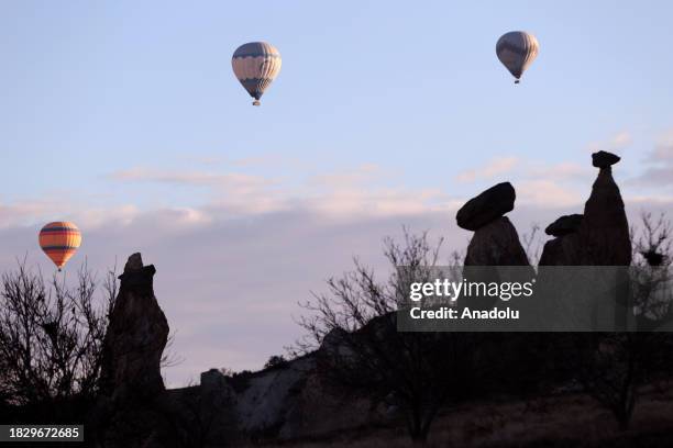 View of hot air balloons flying over valleys of Cappadocia in Nevsehir, Turkiye on December 05, 2023. In 1987, a trial flight with hot air balloons...