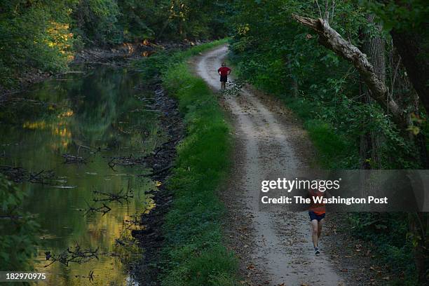 Glen Echo, MD Pascal Girard, of Bethesda, MD, front, jogs with other runners/bikers along the C&O Canal towpath at mile 6.5 on Wednesday, October 2...