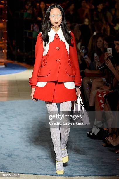 Model walks the runway at the Miu Miu Spring Summer 2014 fashion show during Paris Fashion Week on October 2, 2013 in Paris, France.