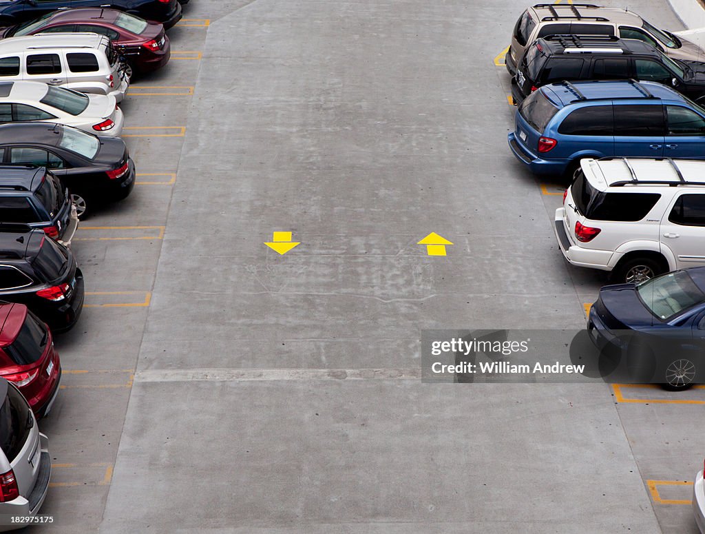 Parking lot with yellow direction arrows