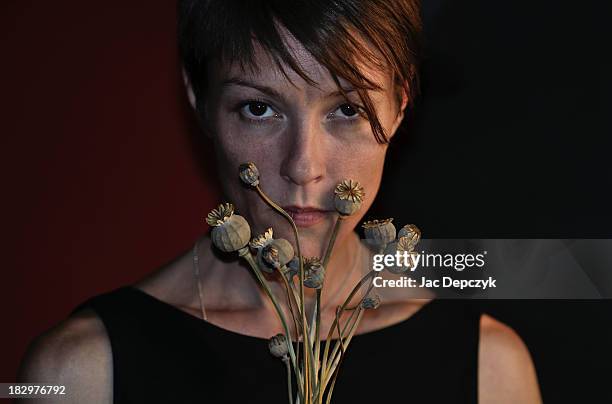 young woman holding a bunch of poppy capsules - depczyk stock pictures, royalty-free photos & images