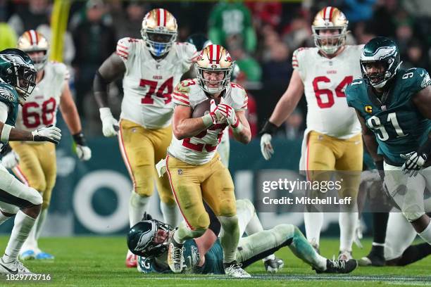 Christian McCaffrey of the San Francisco 49ers runs the ball against Fletcher Cox of the Philadelphia Eagles at Lincoln Financial Field on December...