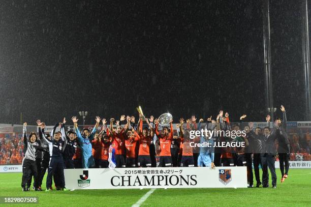 Captain Kosuke Kikuchi of Omiya Ardija lifts the plaque as they celebrate the J2 season champions at the award ceremony following the J.League J2...