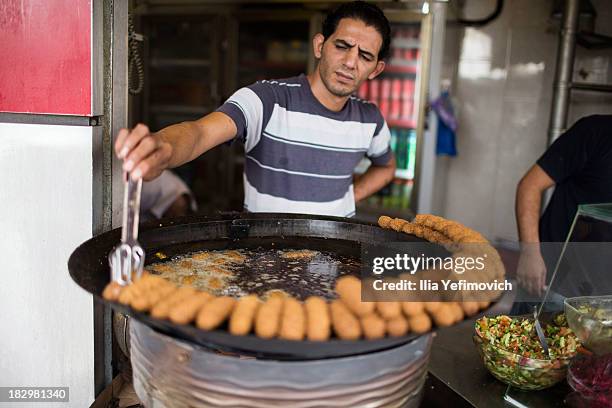 Palestinian man makes falafels on September 23, 2013 in Ramallah, West-Bank. The West Bank and Gaza Strip are inhabited by an estimated 3.33 million...