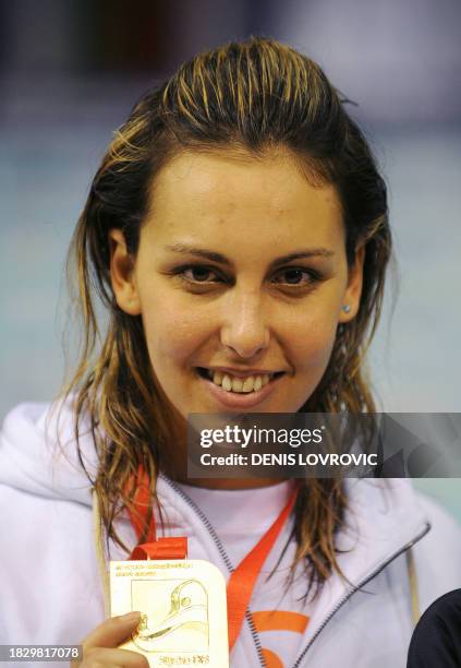 Alessia Filippi from Italy displays her gold medal after winning the women's 800m freestyle race during the European Short Course Swimming...