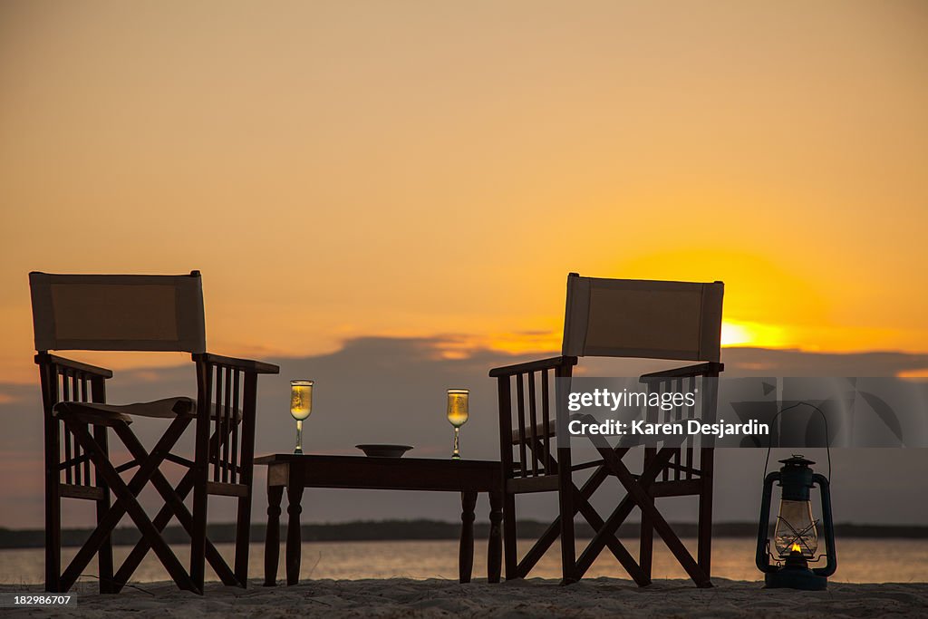 Beach table and chairs for two at sunset