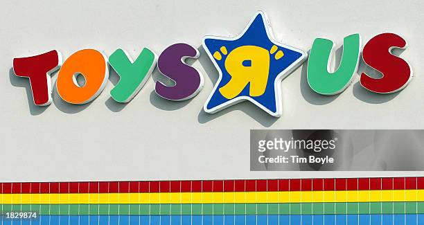 Toys R Us sign is visible at one of its stores January 28, 2002 in Arlington Heights, Illinois. The company reported a 76 percent jump in its fourth...