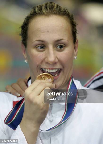 Croatia's swimmer Sanja Jovanovic bites her medal after winning the Women's 50m backstroke final during the European short course swimming...